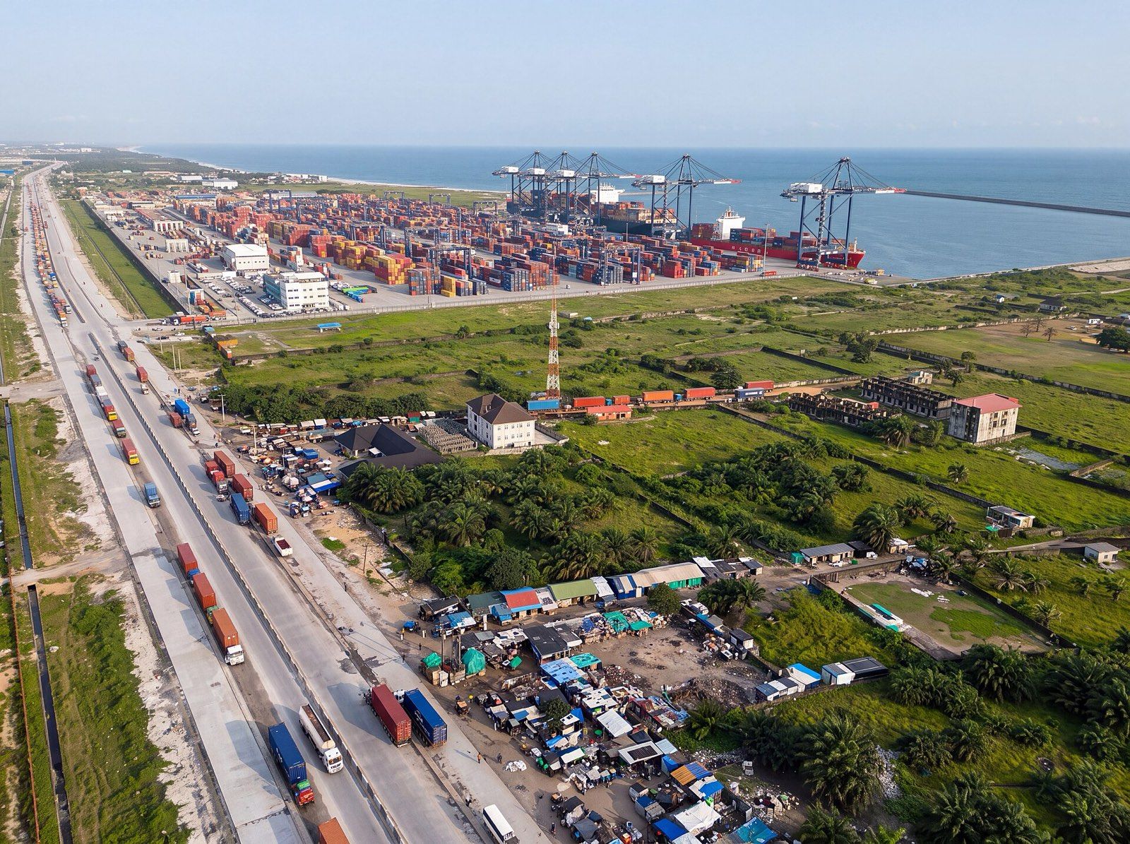 Aerial view of Lekki Deep Sea Port: container cranes and stacked containers on the coast, with trucks queuing on the access road